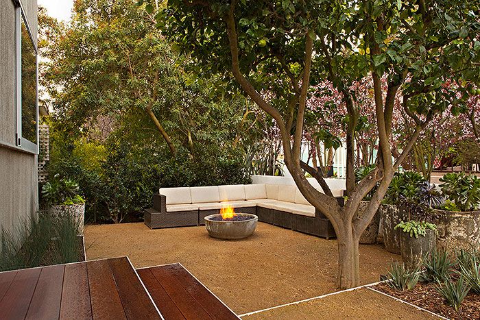 Stone patio with river rock and planting beds